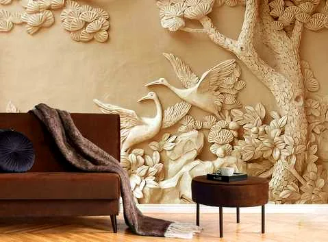 Warm wood-toned relief of cranes and foliage behind a living-room sofa