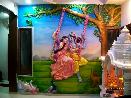 Colourful painted mural of Radha and Krishna on a swing beneath a tree, with a temple to the side