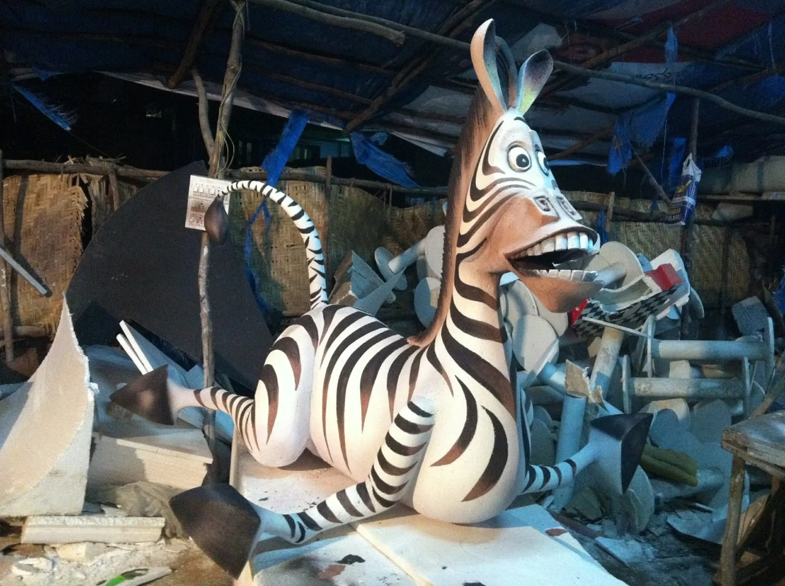 Black and white stylised zebra sculpture with a smiling expression in the workshop